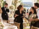 Wedding planner arguing with vendors at an outdoor wedding reception as the bride and groom look distressed.
